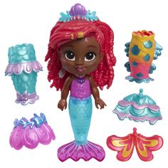 the little mermaid doll is next to her accessories