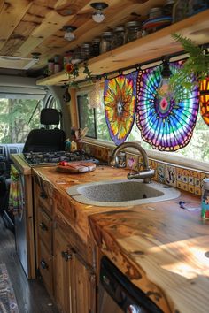 a kitchen with wooden counter tops and colorful lights hanging from the ceiling over the sink