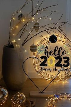 a happy new year's card with lights around it and a tree in the background