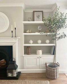 a living room filled with furniture and a fire place in front of a white fireplace