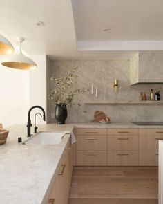 a kitchen with white counter tops and wooden cabinets