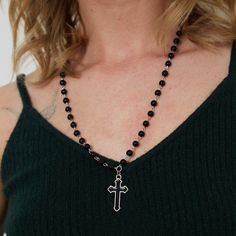 Indulge in edgy elegance with our Silver Gothic Beaded Cross Charm Necklace. Made with stunning black beads and a beautifully intricate cross charm, this necklace is the perfect accessory for anyone looking to make a statement. Showcase your unique style and add a touch of sophistication to any outfit with this one-of-a-kind piece! Good to Know: Adjustable fastening  Silver Plated  Nickel Free  Charm Size 20mm x 10mm  Necklace Length 21" - 24" with Adjuster Edgy Black Beaded Jewelry, Gothic Black Cross Pendant Necklace, Beaded Spiritual Cross Pendant Necklace, Spiritual Black Cross Beaded Necklace, Gothic Beaded Cross Jewelry, Black Beaded Cross-shaped Rosary, Black Beaded Cross Rosary, Black Spiritual Cross Pendant Necklace, Elegant Black Crucifix Cross Necklace