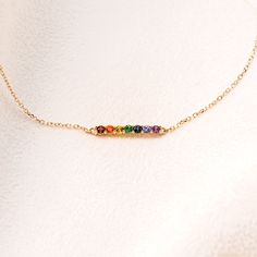 A beautiful rainbow-colored 14K gold bracelet to celebrate pride and love. The rainbow-colored gemstones have a variety of symbolic meanings across many cultures. For some, it is a symbol of hope or good fortune to come. For others, it is a sign of inclusivity or all-embracing love. This piece is the perfect bracelet to be worn on its own or layered with some of your favorite jewelry. - Primary Stone Count - 7 Gemstones: Pink Sapphire, Tanzanite, London Blue Topaz, Green Tsavorite Garnet, Yellow Sapphire, Mexican Fire Opal, & Mozambique Garnet - Weight: 0.5793 DWT (0.90 grams) - Primary Stone Shape: Round -Primary Stone Size: 2mm - Bracelet Closure Type:Spring Ring -Bracelet Type: Link -Surface Finish: Polished -Chain Style: Cable Available in: 14K rose gold, 14K white gold, or 14K yellow Minimalist Rainbow Jewelry As Gift, Minimalist Rainbow Jewelry For Gift, Everyday Rainbow Round Jewelry, Rainbow Multi-stone Bracelets As A Gift, Rainbow Multi-stone 14k Gold Jewelry, Adjustable Multi-stone Rainbow Jewelry, 14k Gold Rainbow Multi-stone Jewelry, 14k Gold Multi-stone Rainbow Jewelry, Adjustable Rainbow Birthstone Jewelry