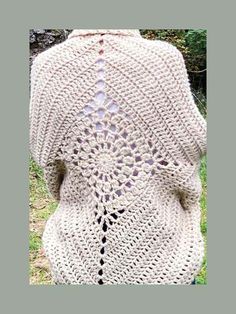 the back of a woman's crocheted sweater