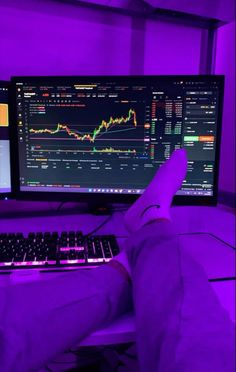 a person sitting in front of a computer with their feet up on the keyboard and monitor