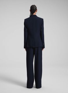 The Brandon Jacket is crafted from drapey wool gabardine in a deep navy hue. This single-breasted design features lustrous satin lapels and a straight fit with a subtle nip-in at the waist, delivering a polished and modern look. Shop Jackets. Styling Tip: Pair with smart trousers and sleek heels for an effortlessly refined approach to tailoring. Smart Trousers, Single Breasted, Design Features, Blue Black, Sleek, Trousers, Satin, Blazer, Wool