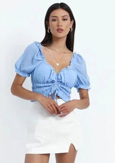 The Emes Shop top is detailed with a sweetheart neckline. and short puffed elasticized sleeves. Features center bust ruching and drawstring tie. This feminine and chic top is perfect for a warm summer day out. Finish off the look with a white mini skirt and heeled sandals.MATERIAL:100% Soft PolyMEASUREMENTS:Small : 4-6 Waist: 25-26.5 in Chest: 33-34.5 in Hips: 35-36.5 in Length: 10.6" in Medium : 6-8 Waist: 26.5-28 in Chest: 34.5-36 in Hips: 36.5-38 in Length: 10.7" in Large : 8-10 Waist: 28-... Trendy Summer Blouse With Gathered Sleeves, Summer Smocked Bodice Puff Sleeve Top, Summer Puff Sleeve Top With Smocked Bodice, Trendy Summer Smocked Top With Gathered Sleeves, Trendy Smocked Top With Gathered Sleeves For Summer, Summer Smocked Top With Ruched Short Sleeves, Summer Brunch Puff Sleeve Top With Smocked Back, Flirty Ruched Tops For Summer, Feminine Summer Smocked Top With Gathered Sleeves