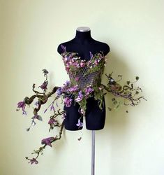 a mannequin with purple flowers on it