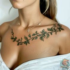 a woman with tattoos on her chest and shoulder