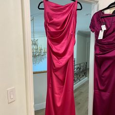 two dresses hanging up in a closet