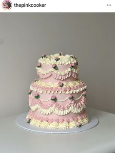 a three tiered cake with pink and white frosting