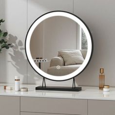 a round mirror sitting on top of a table