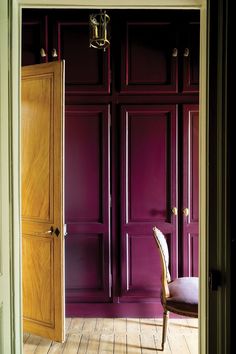 a room with purple walls and wooden doors