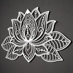 a paper cutout of a flower with leaves on the bottom and center, in white