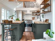 a kitchen with green cabinets and wooden floors