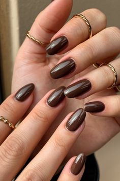 Class up your look with these chocolate brown nails! Ideal for any style, these designs bring a polished and refined touch to any outfit. Hashtags: #ClassyNails #ChocolateBrownManicure #ElegantNailArt #RefinedStyle #brownnailsaesthetic Chocolate Colour Nails, Nail Chocolate Color, Brown Nails Shellac, Chocolate Nails Design Art Ideas, Winter Nails Brown Skin, Chocolate Nail Color, Short Dark Almond Nails, Winter Nails For Dark Skin, Dark Chocolate Brown Nails