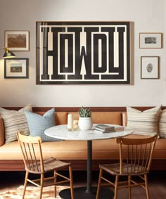 a living room filled with furniture and pictures hanging on the wall over a dining table