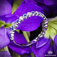 a close up of a ring on purple flowers