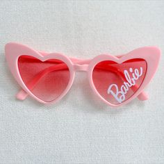 a pair of heart shaped sunglasses with the word barbie written on them