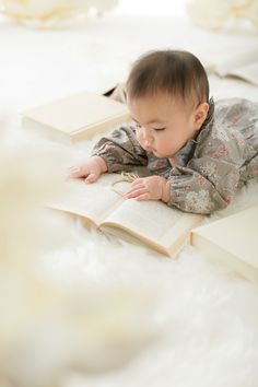 a baby laying on top of an open book