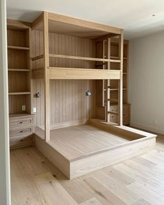 a bunk bed with built in shelves and drawers