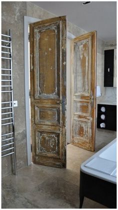 an old door is open in the bathroom