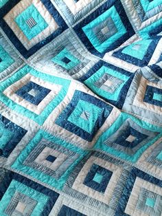 a blue and white quilt with squares on it