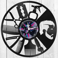 a clock with scissors, combs and other items on it's face in the shape of a wheel