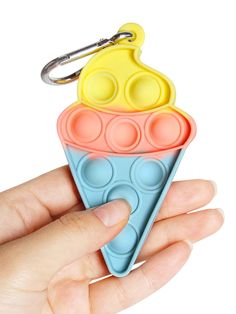 a hand holding an ice cream cone shaped keychain