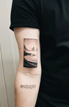 a man with a tattoo on his arm that says hyvinia in black ink