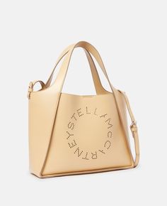 Women Cornflake Stella Logo Crossbody Bag | Stella McCartney US Luxury Beige Shoulder Bag With Logo, Luxury Logo Tote Shoulder Bag, Designer Beige Shoulder Bag With Logo, Beige Logo Tote Shoulder Bag, Designer Tote Bag With Logo, Luxury Beige Bags With Logo, Luxury Beige Bag With Logo, Beige Top Handle Bags With Logo, Beige Top Handle Shoulder Bag With Logo