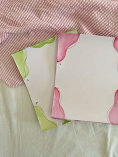 two sheets of paper with pink and green designs on them sitting next to each other