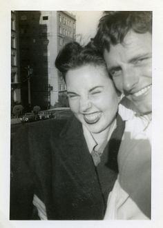 an old black and white photo of a man and woman posing for a picture together