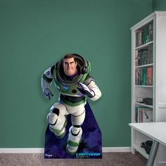 a cartoon character is standing in front of a book shelf and bookshelf with a green wall behind it