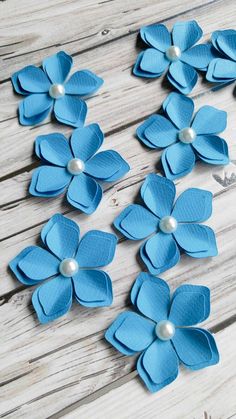 blue paper flowers with pearls on them