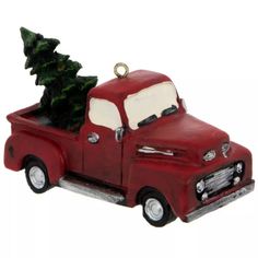 a red truck with a christmas tree in the back