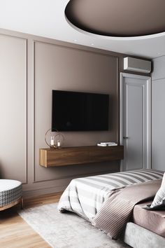 a bedroom with a large bed and a flat screen tv mounted on the wall above it