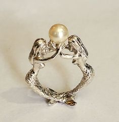 This is a beautiful two mermaids sterling silver  ring holding a 7.5 mm natural pearl  Can be ordered in sizes 6 to10 Ocean Rings Aesthetic, Mermaid Wedding Ring, Sculptural Rings, Mermaid Rings, Two Mermaids, Sea Ring, Mermaid Accessories, Silver Pearl Ring, Mermaid Ring