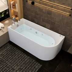 a bath tub sitting next to a sink in a bathroom