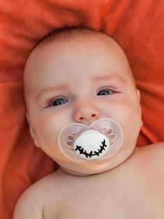 a baby with a pacifier in it's mouth