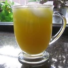 a glass cup filled with liquid sitting on top of a counter