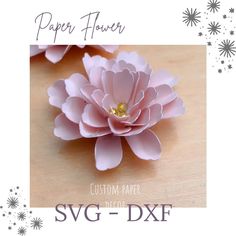 the paper flower is pink and has gold centers