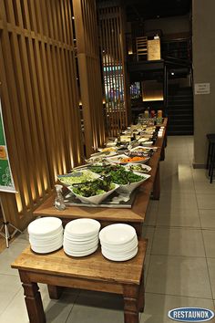 a long table with plates and bowls on it