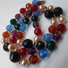 Vintage deco 24inch multi colour crystal necklace.  Delightful necklace of different coloured multi faceted Crystal's on string with pull ring fastener. Great condition of beads, may need to be restrung in near future if worn on very regular basis. Period drama style necklace.  Delightful with all outfits. Multicolor Faceted Jewelry For Party, Costume Jewelry Crystal Necklaces With Faceted Beads, Elegant Multicolor Faceted Crystal Necklaces, Vintage Multicolor Faceted Beads Necklace, Multicolor Crystal Necklaces With Round Beads, Vintage Multicolor Jewelry With Faceted Beads, Multicolor Faceted Beads Crystal Necklaces For Parties, Multicolor Faceted Beads Crystal Necklace For Party, Shoulder Duster Earrings