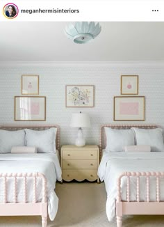 two twin beds in a bedroom with pink and white decor