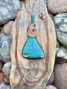 "Gem silica with copper and pacific blue wire wrap Comes with 18\" sterling silver plated chain shown in photos. Pendant measures 1-13/16\" x 15/16\"" Turquoise Necklace With Copper Wire, Wire Wrapped Turquoise Pendant Necklace, Blue Copper Pendant Necklace, Turquoise Copper Wire Necklace Gift, Blue Copper Wire Pendant Necklace, Turquoise Copper Wire Necklace As Gift, Turquoise Copper Wire Necklace For Gift, Blue Copper Wire Wrapped Necklaces, Blue Copper Wire Wrapped Necklace