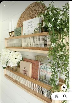 two wooden shelves with books and flowers on them