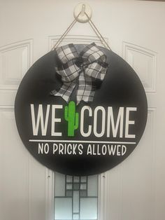 a sign that says we welcome no prick's allowed hangs on the front door