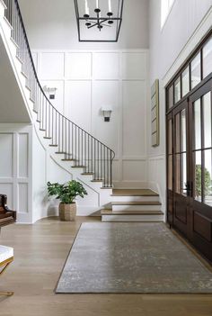 an elegant entryway with stairs leading up to the second floor