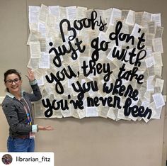 a woman standing in front of a sign with writing on it